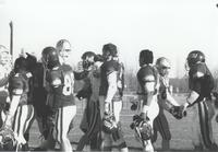 Maverick football players shaking hands with unidentified Morning Side football players after game at Blakeslee Stadium; Mankato State University; 1989