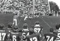 MSU Mavericks shown playing football against NDSU; Unidentified players running at each other and blocking each other; Mankato State University; 1989